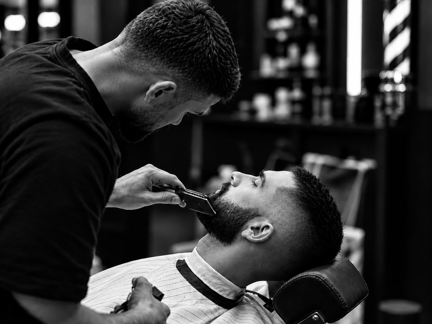 Barber shaping a client's beard with a trimmer