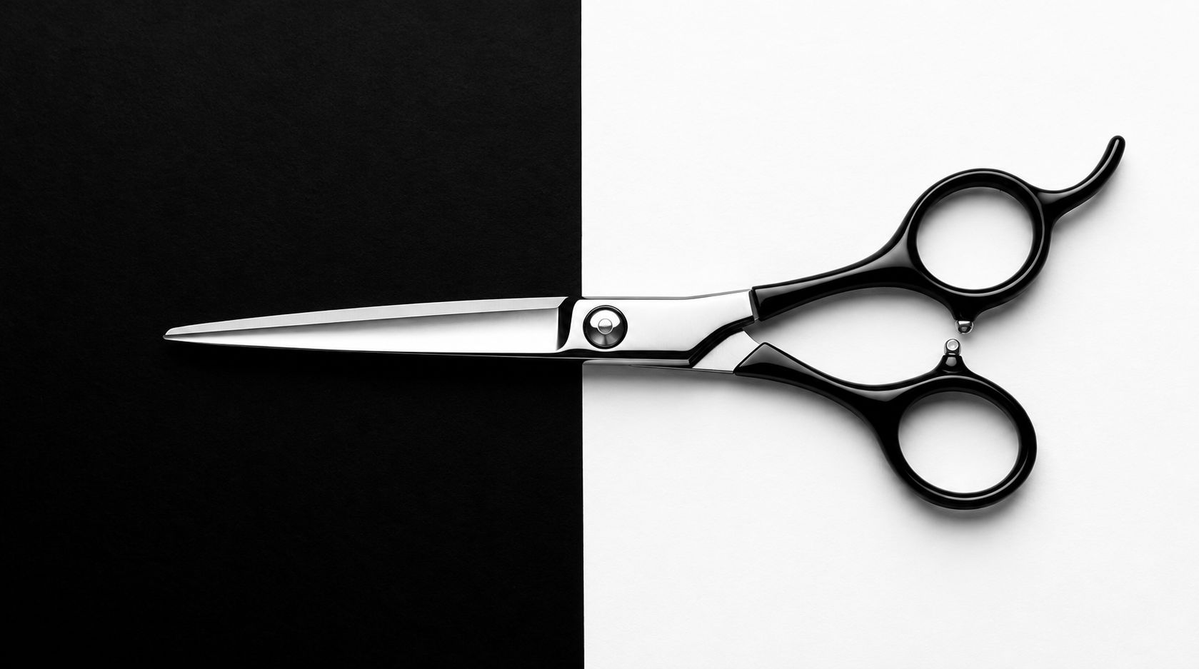 Professional barber scissors on a split black and white background